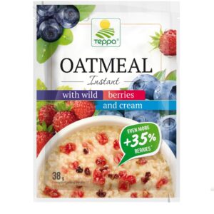 Instant oatmeal porridge with strawberries, blueberries, bilberries and cream
